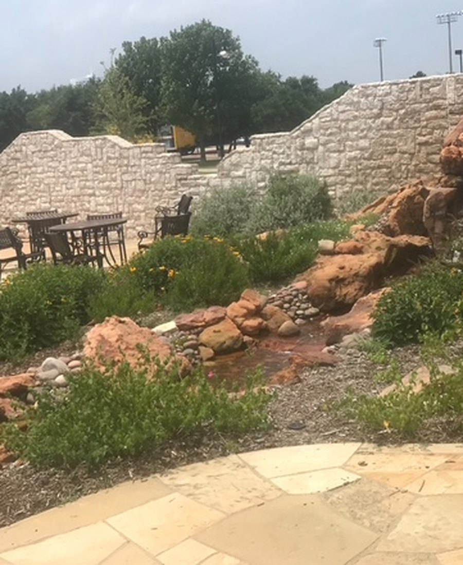 Outdoor spaces that manage water, stone, shade, and everyday use.